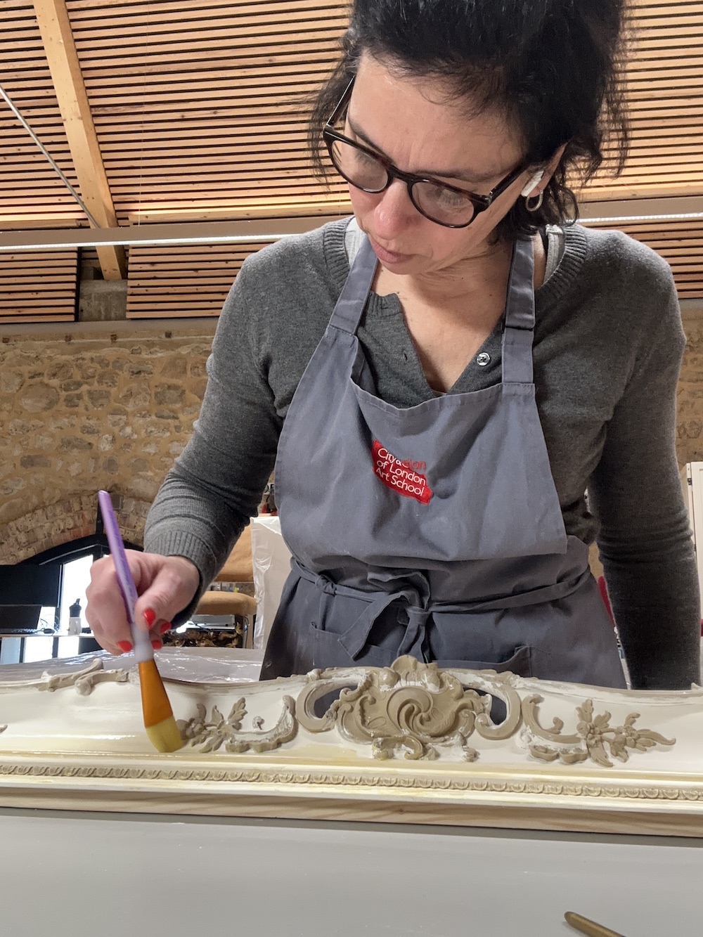 Applying bole to the gesso and compo.