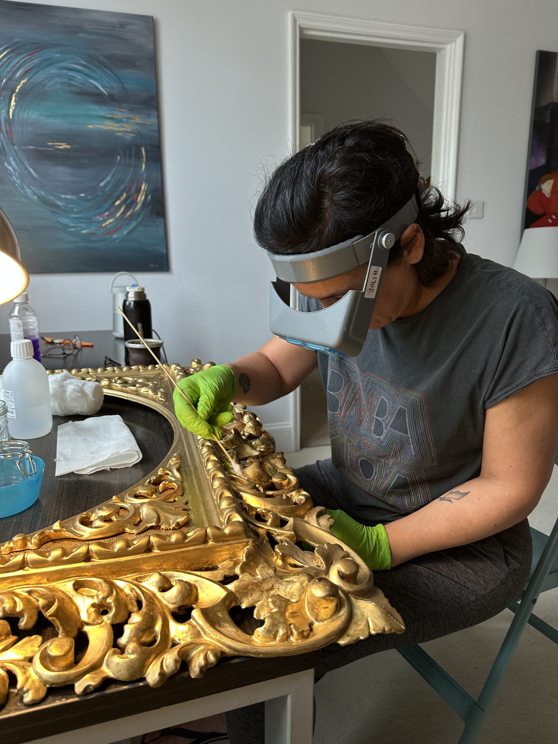 Cleaning of the bronze layer on top of the original oil gilded scheme.